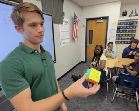 High School senior uses Rubik's cube skills to teach 8th graders math