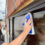 Window washer cleans small business windows for free, helps owners go viral on social media