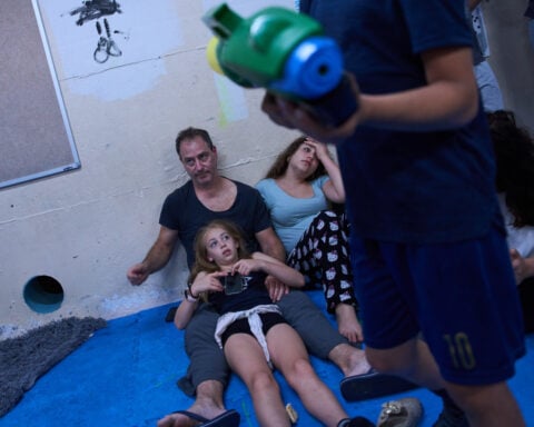 After morning of sirens, Israelis fall back into well-worn war routines