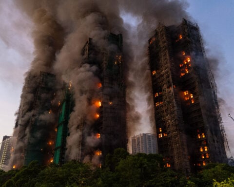 Hong Kong charges 7 people and 2 firms over deadly fire that killed 168