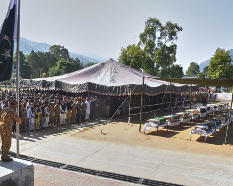 A mass funeral is held for 22 Pakistani soldiers who died in a helicopter crash in Kashmir