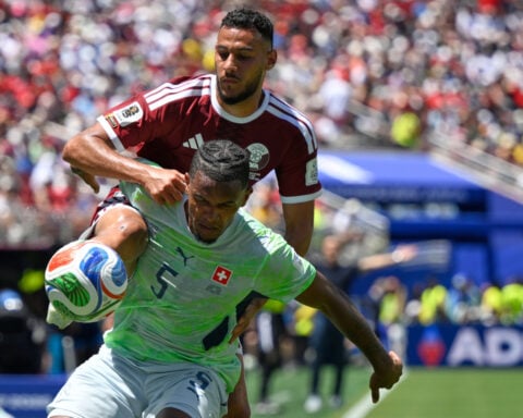 Boualem Khoukhi's goal on header in stoppage time earns Qatar a 1-1 World Cup draw with Switzerland