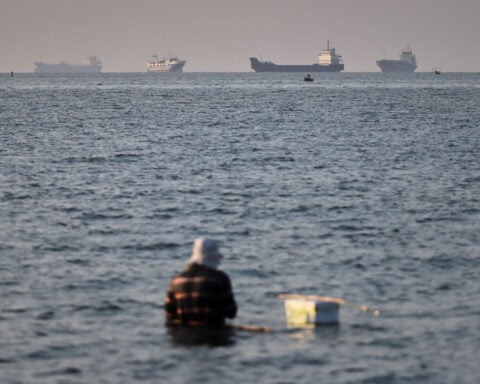 Trump says the Strait of Hormuz is reopened. But most ships are staying put