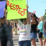 Protesters gather outside Angelini's Ristorante after owner's controversial video