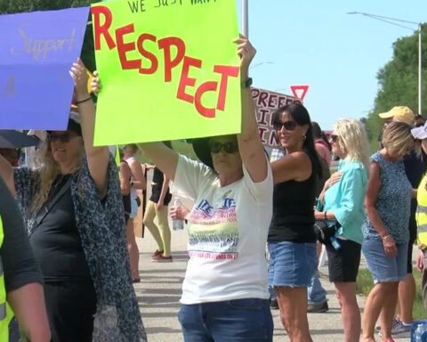 Protesters gather outside Angelini's Ristorante after owner's controversial video
