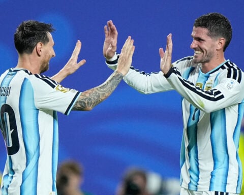 Messi has his first World Cup hat trick as defending champion Argentina beats Algeria 3-0 in opener
