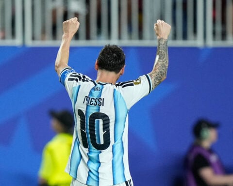 Messi has his first World Cup hat trick as defending champion Argentina beats Algeria 3-0 in opener