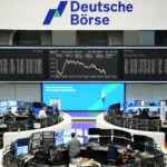 European shares flat as investors await Iran deal details, Fed policy; BMW slides