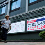 Stocks set records in Japan, South Korea; dollar gets Fed boost