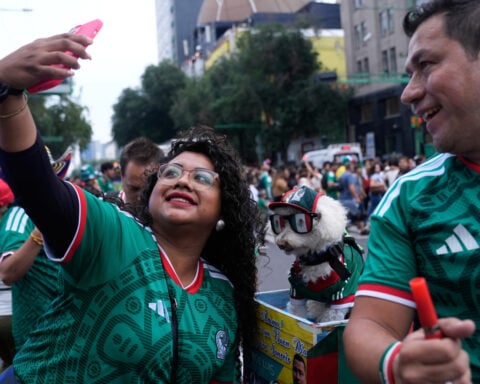 Rescue dog Osito steals hearts at the World Cup, one bike ride at a time