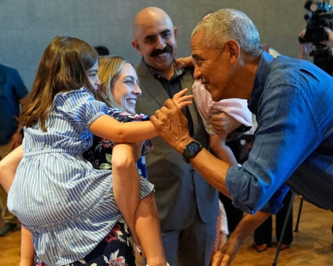 Barack and Michelle Obama surprise first visitors to newly opened presidential center