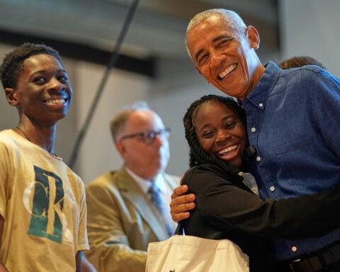 Barack and Michelle Obama surprise first visitors to newly opened presidential center