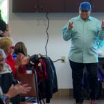 Father's Day fashion show participants model clothing made by senior center's sewing group