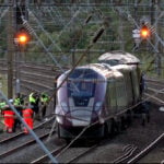 Two trains collide north of London, killing at least 1 person and injuring dozens