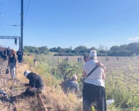 One killed and dozens injured in train collision north of London