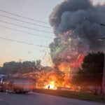 Fireworks stand fire caught on video with flames and fireworks shooting skyward