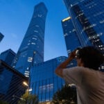 Small plane crash at Beijing high-rise kills the pilot and injures 13, authorities say