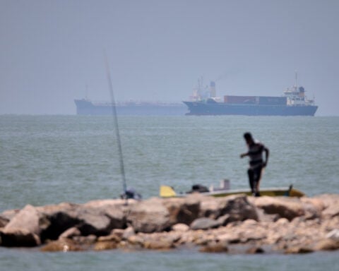 Iranian drones attack Bahrain and a ship is struck in the strait after US airstrikes