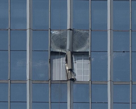 A small plane has crashed into a Beijing high-rise, killing the pilot and injuring 13