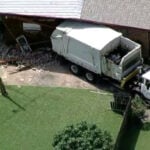 Garbage truck breaks loose while being towed, rolls into Dallas home, authorities say