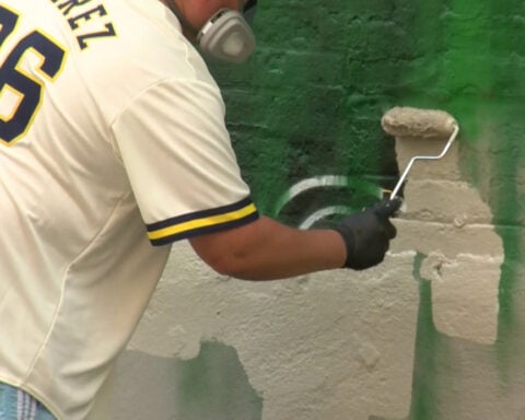 Artist repairs mural of Giannis Antetokounmpo in downtown Milwaukee after vandalism