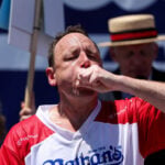 Eating champion Joey Chestnut defends title but blames heat for lower hot-dog tally