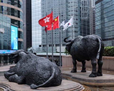 Shares edge higher in Asia as oil dips, earnings loom