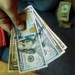 Dollar near two-week lows as rate-hike bets recede, embattled yen in focus