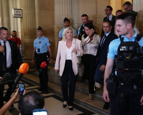Le Pen says she'll run for French presidency next year despite court-ordered monitor