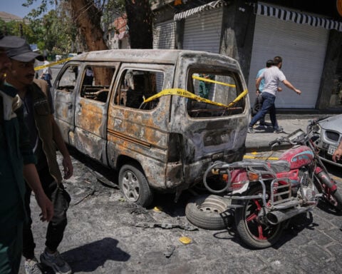 Explosions rock Syria's capital as French President Macron visits