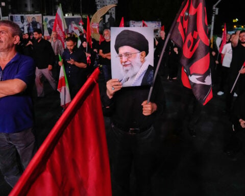 Iran reports new attacks on military targets on its largest island near the Strait of Hormuz