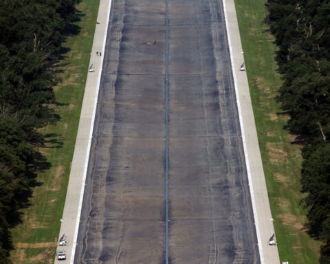 Drained Reflecting Pool reveals Trump's 'American flag blue' liner is now closer to gray