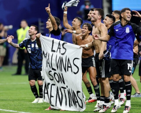 Soccer-Argentine players brandish political Falklands flag after England match