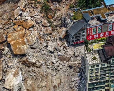 A huge landslide in southwest China buries homes and force more than 1,000 to evacuate