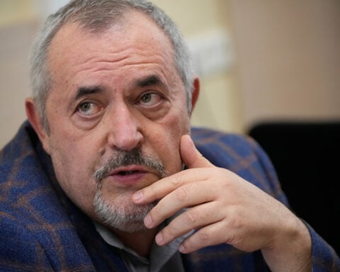 A Putin critic is convicted on charges that will keep him from campaigning for Russia's parliament
