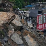 Rescuers race to find survivors in the rain after a landslide in China kills at least 8