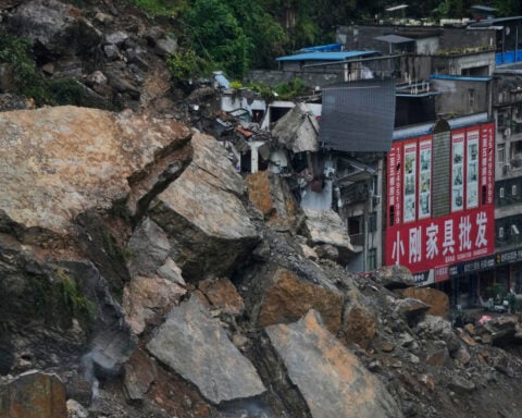 Rescuers race to find survivors in the rain after a landslide in China kills at least 8