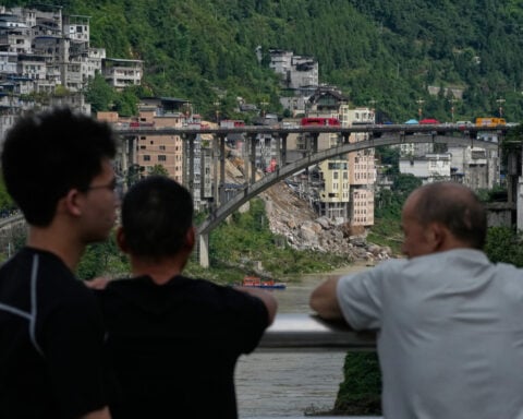 Rescuers race to find survivors in the rain after a landslide in China kills at least 8