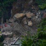 Rescuers in China search the rubble for survivors of landslide that killed 8 and left 34 missing