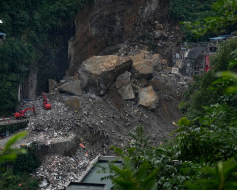 Rescuers in China search the rubble for survivors of landslide that killed 8 and left 34 missing