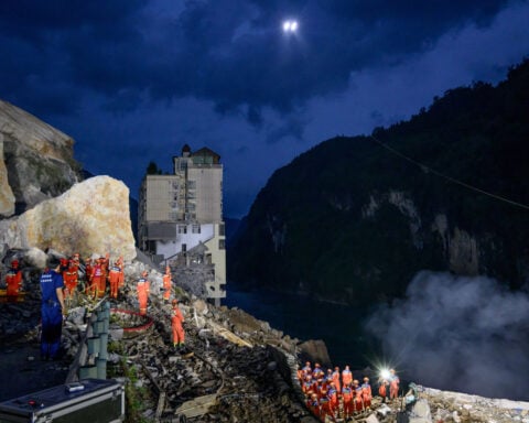 Chinese rescuers use explosives to clear boulders trapping landslide victims