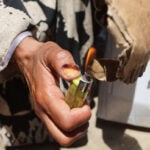In Gaza's tent camps, a cigarette lighter becomes a lifeline
