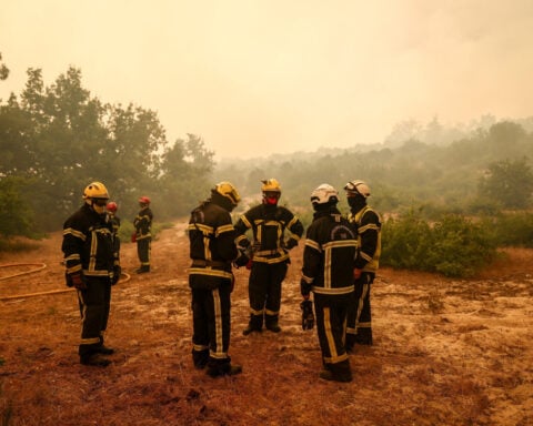 Tens of thousands flee fires in France, blazes merge outside Madrid