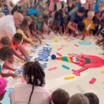 Baltimore kids smash a 2,000-pound birthday cake with Duff Goldman to celebrate Mr. Bubble's 65th birthday