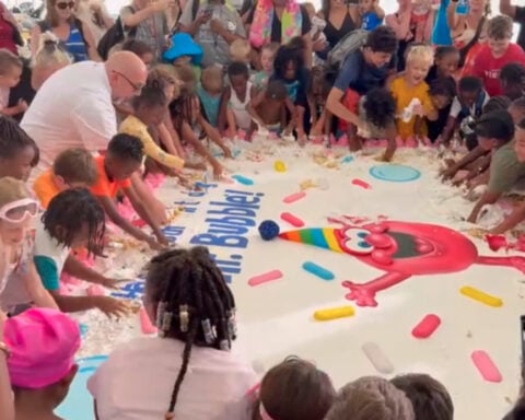 Baltimore kids smash a 2,000-pound birthday cake with Duff Goldman to celebrate Mr. Bubble's 65th birthday