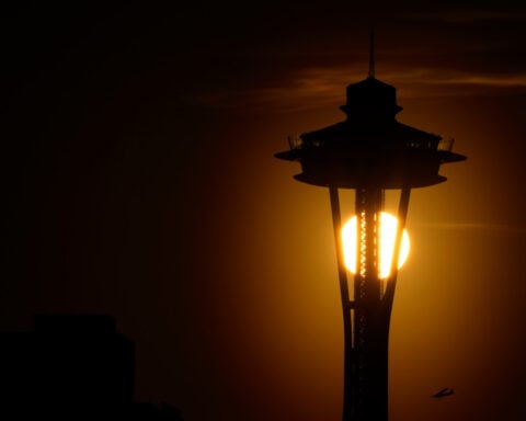 Seattle police are searching for two men who parachuted from the Space Needle