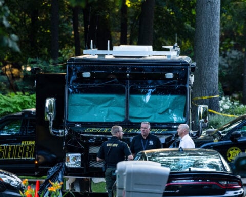 Officials say man killed wife and 6 kids, then himself, before all were found in Michigan home fire