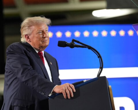 The Latest: Trump praises his sweeping tariffs while in Michigan for a speech on the economy