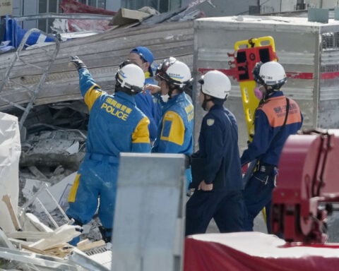 Rescuers search for survivors after a quake kills 18 in southwestern Japan