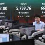 Oil prices slip and Asian shares are mostly lower as investors sell chipmaker stocks